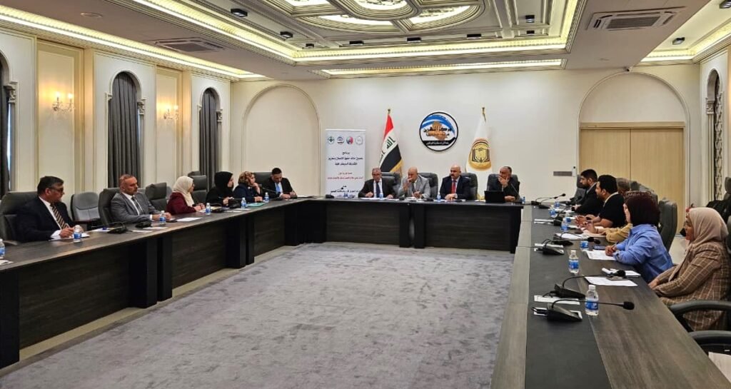 Formal meeting in a large conference room with people seated around a U-shaped table